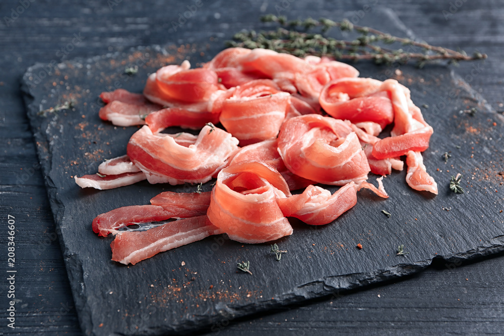 Rashers of bacon on slate plate