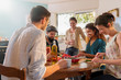 © jackfrog - Multi-ethnic group of friends cooking lunch in the kitchen.