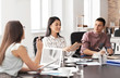 © Pixel-Shot - Young people having business meeting in office