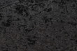Luxurious feel of a black or dark gray velour cloth enhanced by its highly detailed texture background, featuring a lush and plush surface created from densely packed and closely woven fibers.