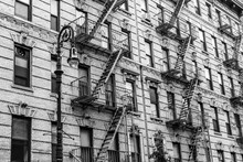 A Fire Escape Of An Apartment Building In New York City. Graphical Black And White Image.
