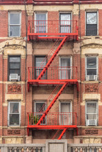 Traditional Red Fire Escape Of An Apartment Building In New York City.