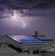 House With Solar Panels In Thunderstorm