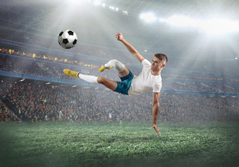 Soccer player on a football field in dynamic action at summer da