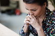 © Maskot - Close-up of tired thoughtful businesswoman with arms crossed at office