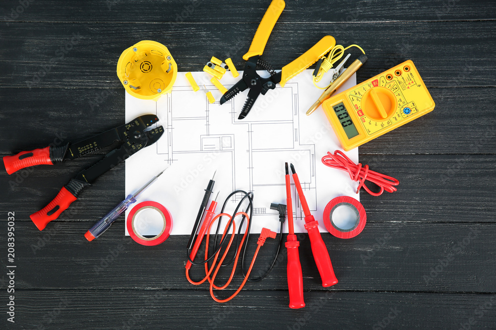 Flat lay composition with electrical tools and house plan on wooden background