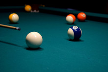 Colored Balls Of The American Pool And Cue On The Billiard Table