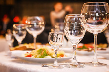 Fancy Wedding Goblets Glasses Laying On The Table With Foods At The Wedding Banquet. Concept Of Wedding Decorum