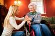 © didesign - Young cute woman comfort her grandmother in wheelchair