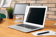 © Pixel-Shot - Stylish workplace with laptop on table