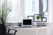 © Pixel-Shot - Stylish workplace interior with laptop on table