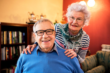 Portrait of smiling senior couple in love at home