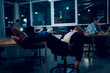 © Svyatoslav Lypynskyy - Tired man sleeping in office after overworking. Exhausted businessman sleeping in his office chair with his legs up on office table in middle of night.