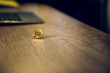 © Svyatoslav Lypynskyy - Bitcoin on wooden desk surface. Golden bitcoin lying on table on its edge with small part of computer to be seen in background.