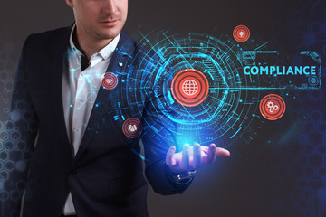 Wall Mural - Business, Technology, Internet and network concept. Young businessman working on a virtual screen of the future and sees the inscription: Compliance