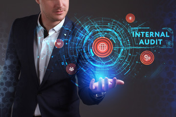 Wall Mural - Business, Technology, Internet and network concept. Young businessman working on a virtual screen of the future and sees the inscription: Internal audit