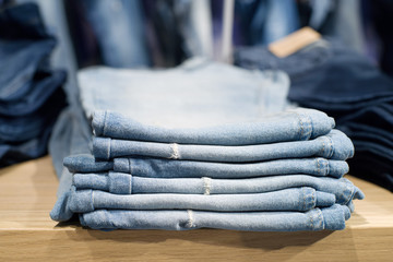 Wall Mural - Piles of jeans on a counter in shop