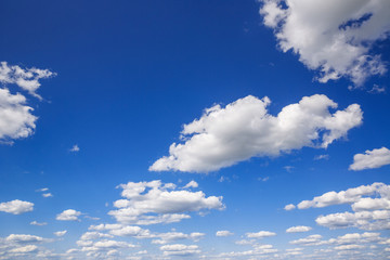 blue sky with white puffy clouds. clouds in the blue sky.