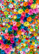 Bright colorful artificial flowers as a background