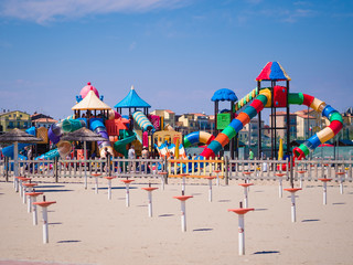 Wall Mural - Playground with colorful structures on the beach.
