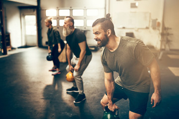 Fit people working out with weights at the gym