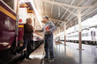 © chomplearn_2001 - Two Asian business people handshake with warm welcome at the train station,