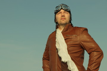 Vintage pilot with leather cap, scarf and aviator glasses  - Portrait of a man in historical pilot clothing