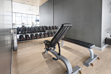 Wall Mural - Dumbbell set and Equipment in modern gyms fitness, At luxury wood room