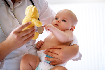 Wall Mural - Baby examined by pediatrician