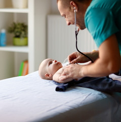 Wall Mural - Doctors with stethoscope examining baby