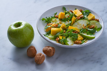 Wall Mural - Arugula mango and apple salad healthy