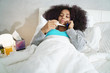 Woman With Fever Using Thermometer And Calling Doctor By Phone