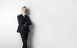 © SFIO CRACHO - Portrait of bearded confident gentleman wearing trendy suit standing over empty white background. Copy Paste text space.