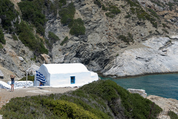 Wall Mural - Amorgos, Greece-August 3, 2017.Small kids photographed in front of the small entrance of Agia Anna Chapel on Amorgos island, Greece, Cyclades.