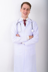Wall Mural - Young handsome man doctor against white background