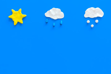 Wall Mural - clear, rainy, snow weather icons on blue background top view copy space