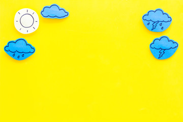 Wall Mural - modern weather icons set on yellow background top view copy space
