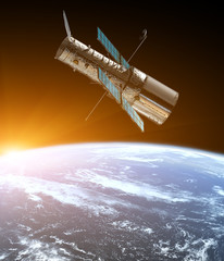 Wall Mural - space telescope in the orbit of planet earth. sunrise. solar system. some elements of this image are