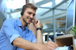 © ty - Smiling friendly handsome young male call centre operator.