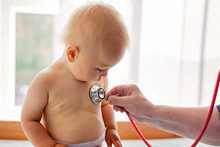 Doctor Examining Toddler Child Patient With Stethoscope.