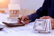 © A Stockphoto - Bookkeeper or financial inspector hands making report, calculating or checking balance. Home finances, investment, economy, saving money or insurance concept.;