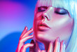© Subbotina Anna - Fashion model woman in colorful bright sparkles and neon lights posing in studio, portrait of beautiful girl, trendy glowing make-up
