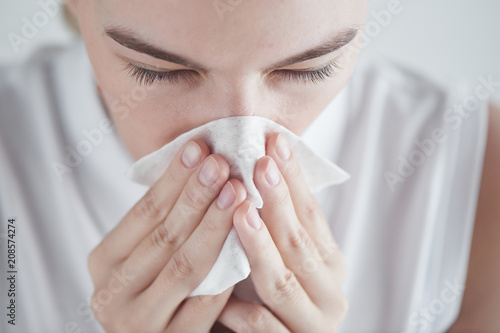 Fotografie, Obraz Rhinitis. Girl with napkin on white background