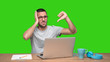 © agongallud - Loser young man sitting at his desk - Green background