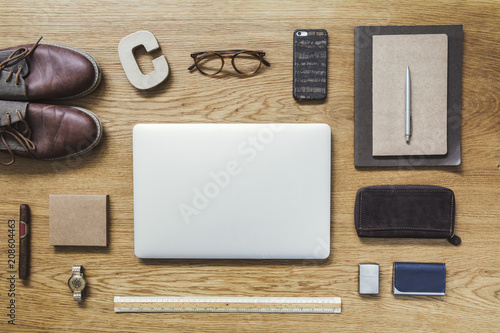 Modern Composition Of Flat Lay On Wooden Desk With Laptop Phone