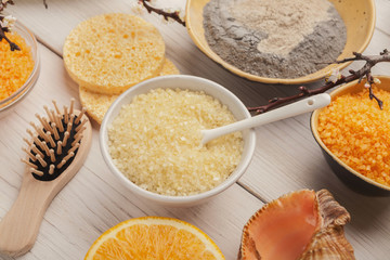 Wall Mural - orange sea salt and face cream on white wood