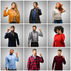 Canvas Print - Group of mixed people, women and men happy and surprised cheering expressing wow gesture pointing up