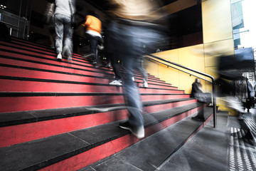 Blurred motion of people walking up the stairs into a building in melbourne, Australia