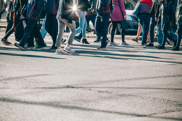 Blurred motion of people legs crossing street in Melbourne CBD with copy space