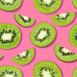 Trendy minimal summer seamless pattern with whole, sliced fresh fruit kiwi on color background